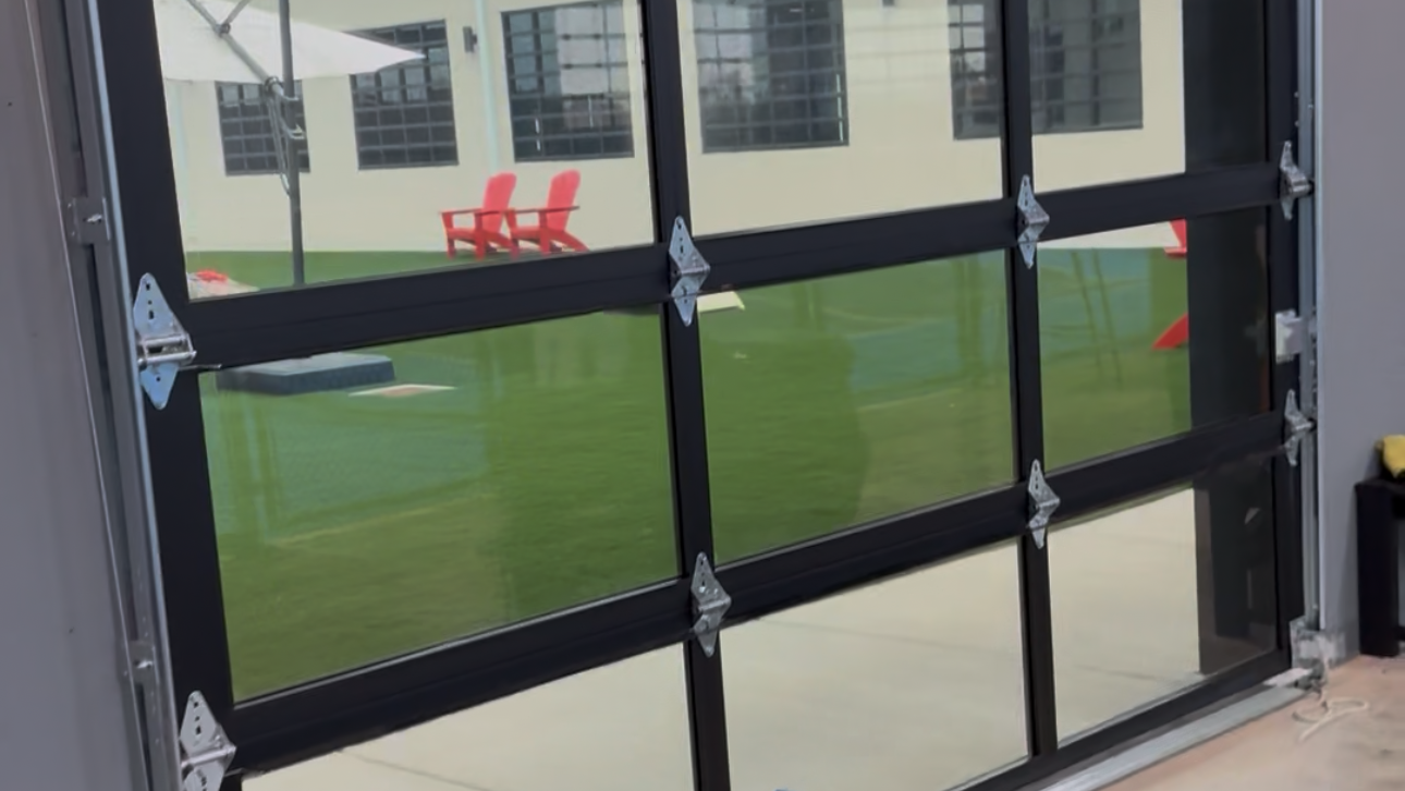 Modern glass garage door with a bench and cushion in front